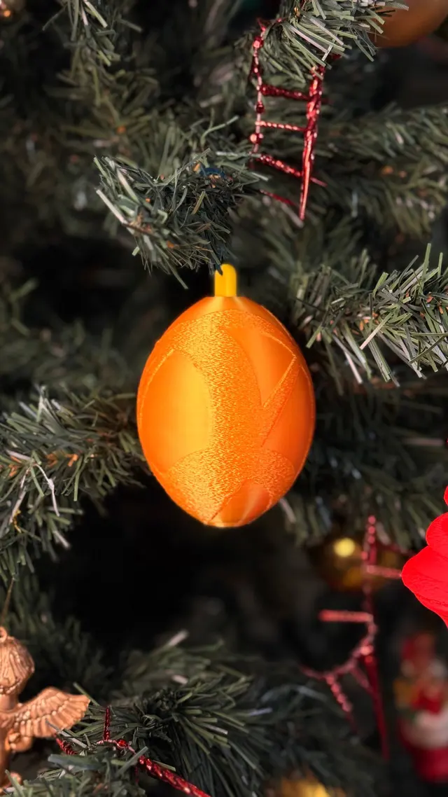 The orange bauble hanging among the branches