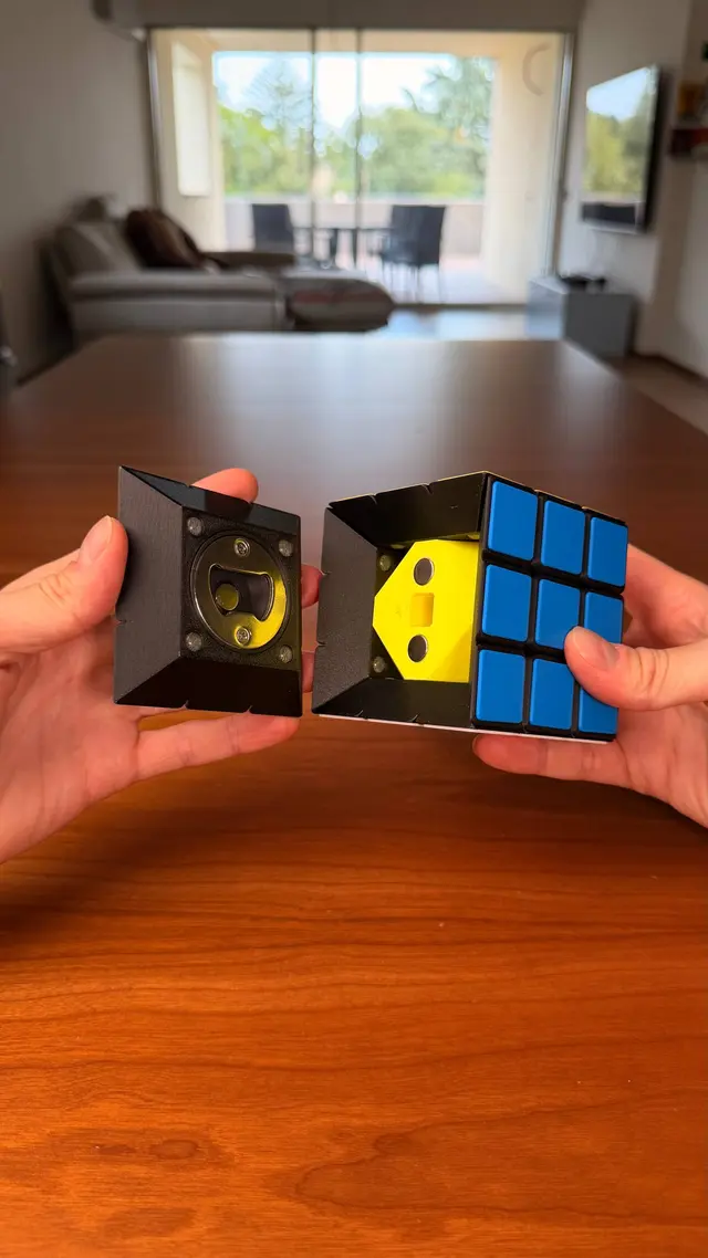 Two hands pull apart the two halves of the cube