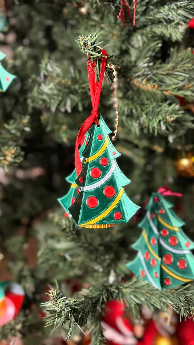 The little tree hanging from a branch of the Christmas tree