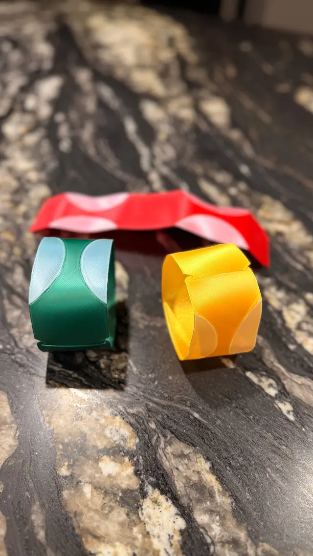 The three strips folded into rings before slotting them together