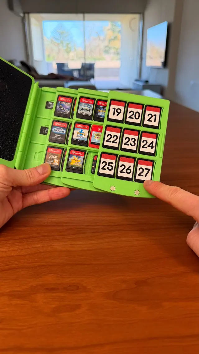 Two hands show a page full of numbered cartridges