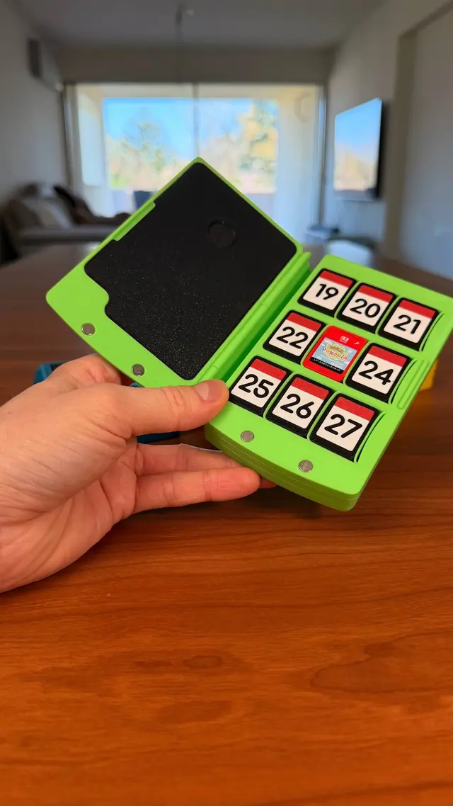 The Games Book open in a hand with its closing magnets