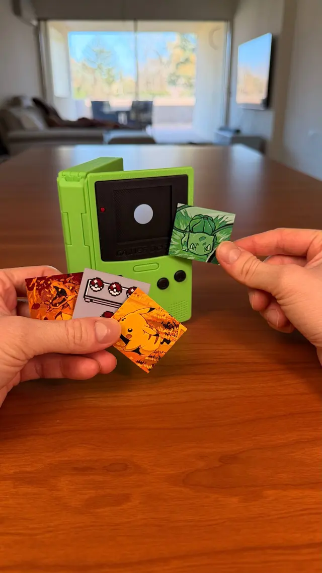 Two hands show the interchangeable illustrated screens