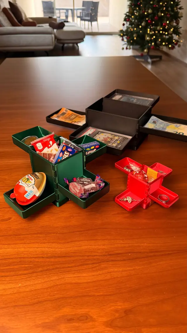 Three open Gift Reveal boxes, full of sweets, banknotes and collectible cards
