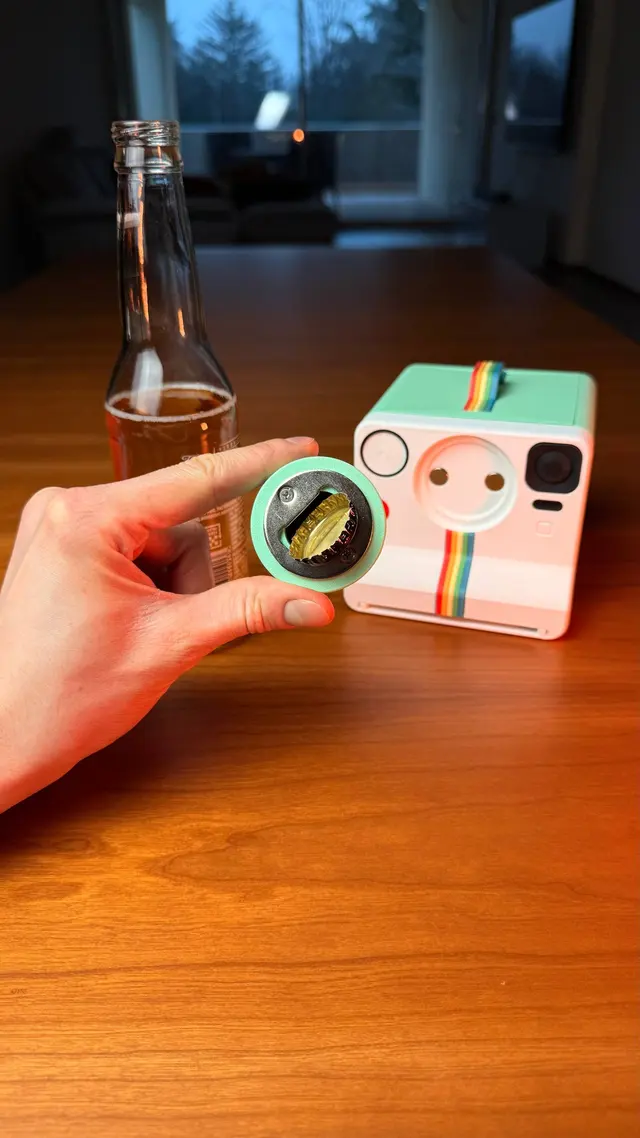 The removed lens used as a bottle opener