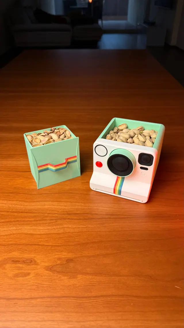 The camera with the lid open over the compartment