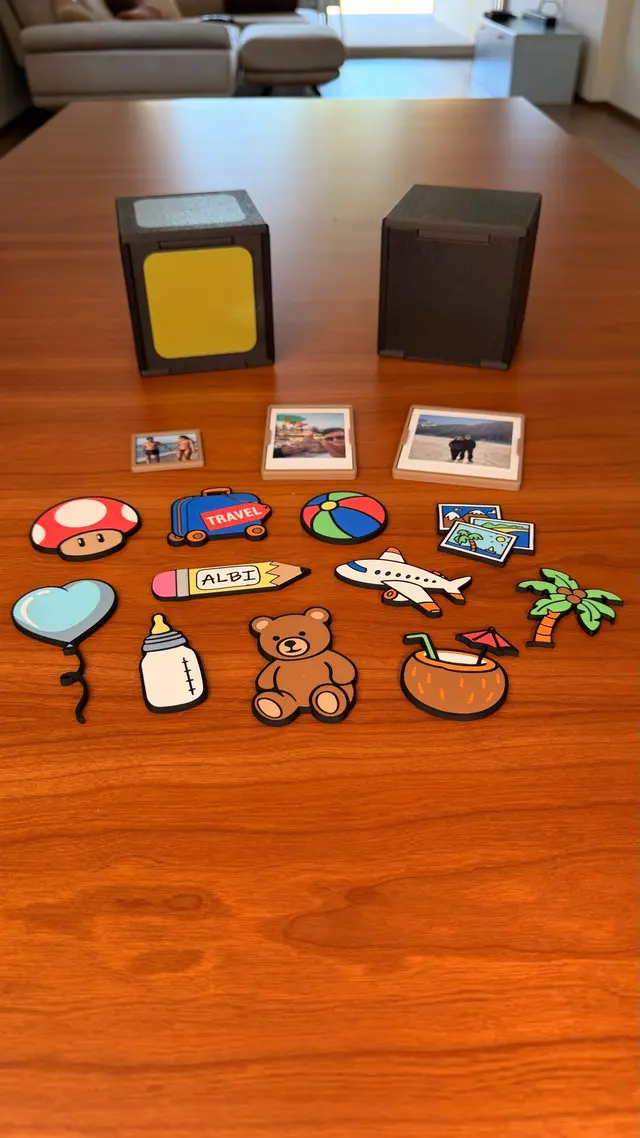 The decorative magnets scattered on the table next to the cubes