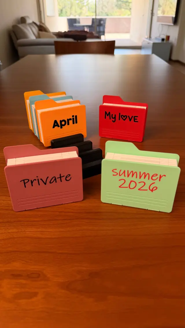 Four closed albums with different words on the cover: April, My love, Private, Summer 2026