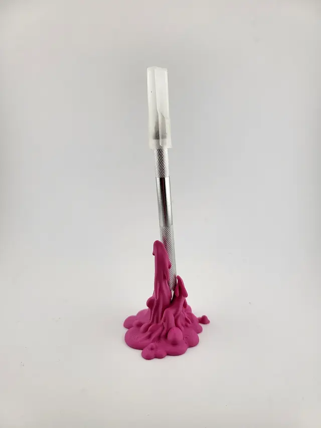 Pink Slime pen holder with an upright pen