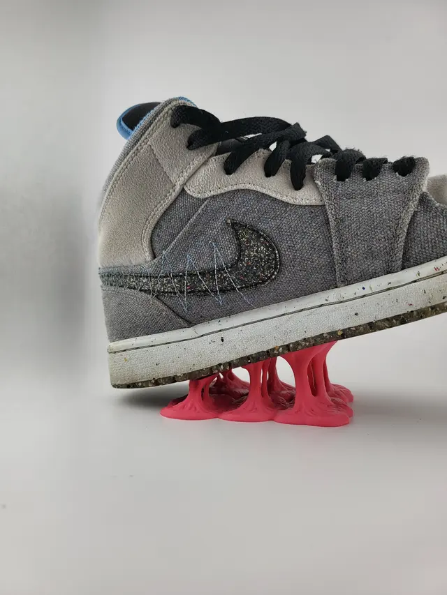 Low Bubble Gum display stand with a grey sneaker, another view
