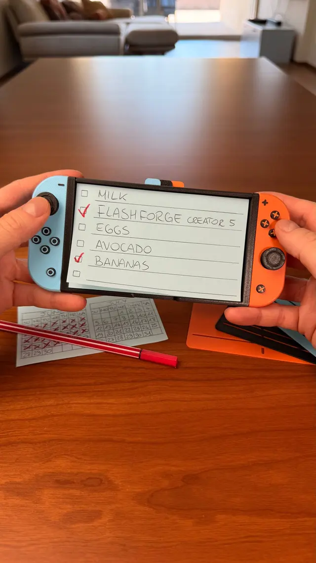 Two hands holding the Switchnote with a shopping list on the sticky note