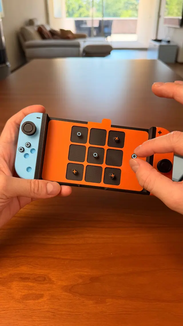 The magnetic tic-tac-toe under the screen, with the buttons as pieces