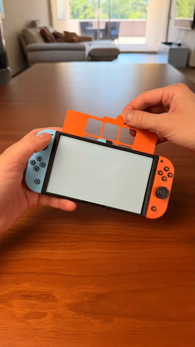 An orange template resting on the sticky note on the screen