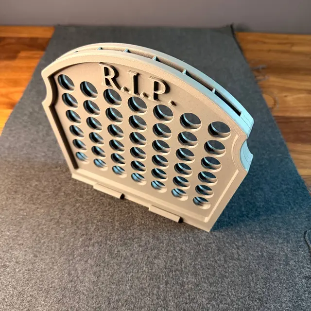 The side with R.I.P. written on it and the four-in-a-row grid