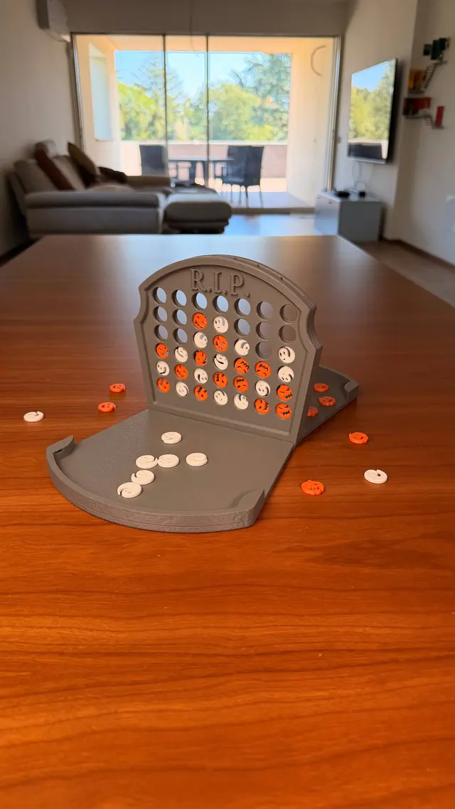 The game open on a wooden table, with white and orange pieces