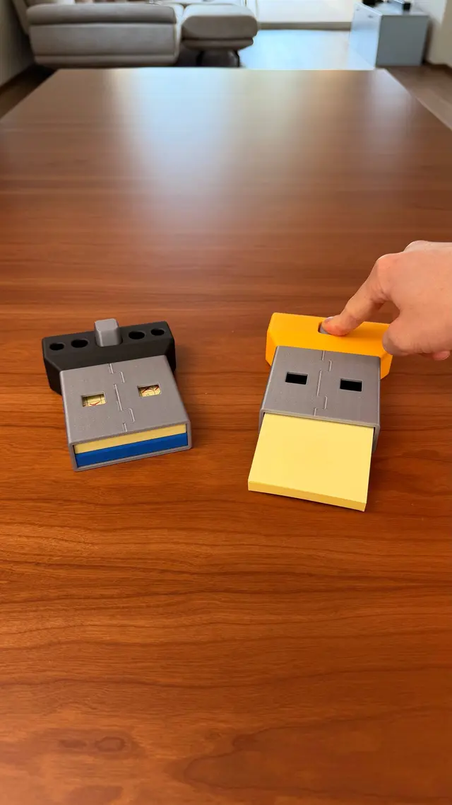 A hand presses the button and the sticky note pad rises